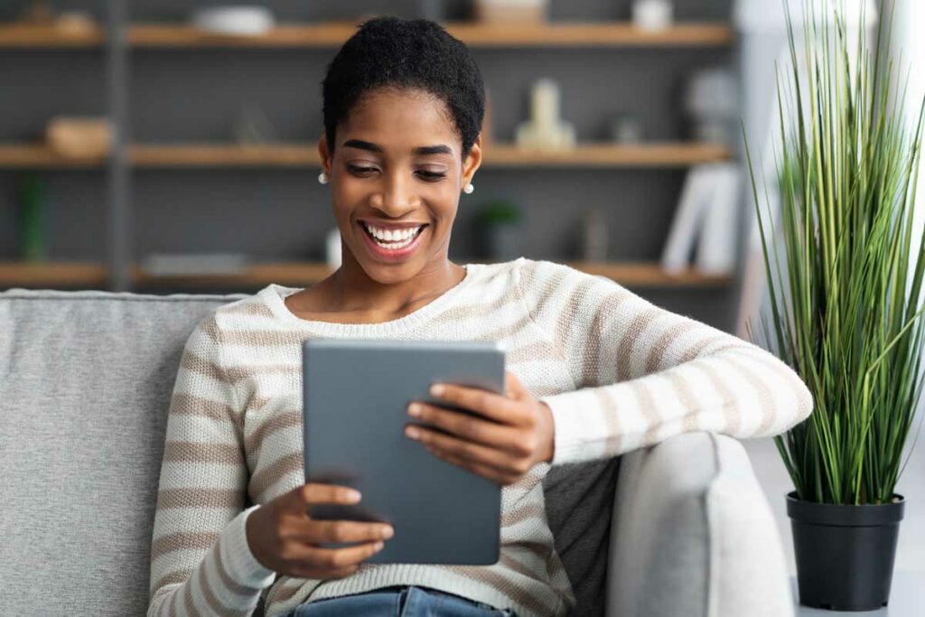 Woman reading newsletter on tablet