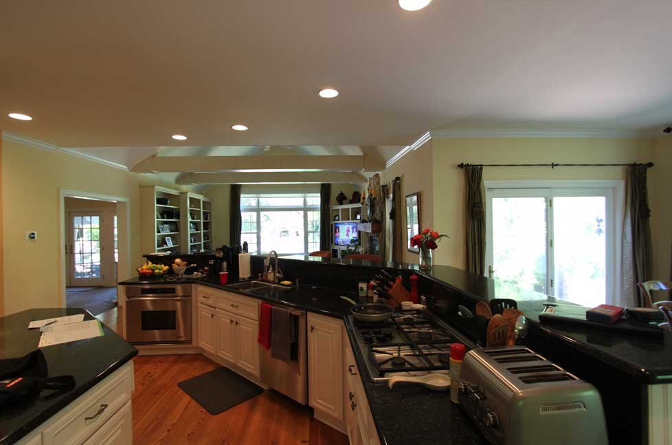 A custom kitchen island designed in a contrasting dark green