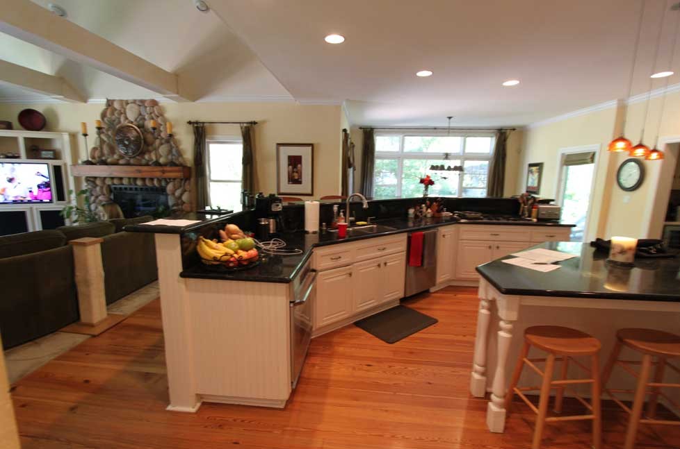 this functional island includes plenty of cabinet space with custom pull-out drawer systems