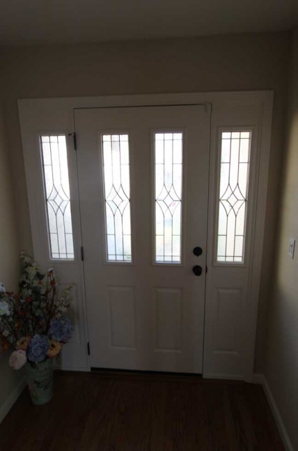 The wood front door and fireplace mantel were stained a rich color to complement the new hardwood floor