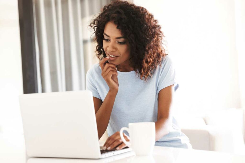 Woman looking at houzz to get ideas for her bathroom remodel